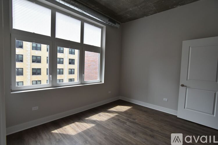 A room with a large window overlooking a building.
