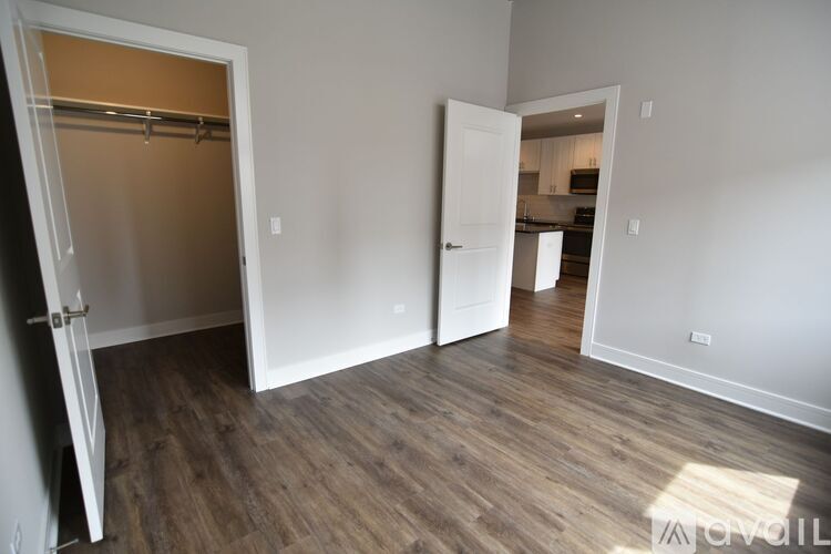 A room with a white door and a white wall.