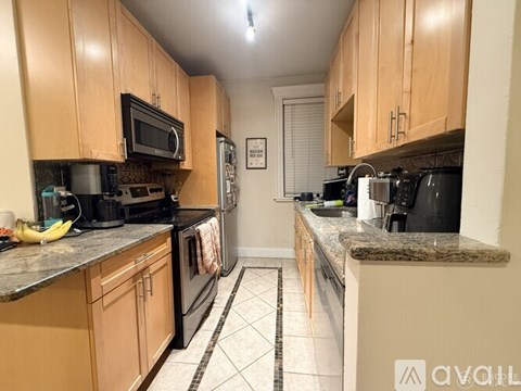 A kitchen with wooden cabinets and black appliances.