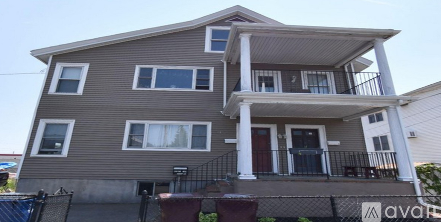 A two-story house with a balcony on the second floor.