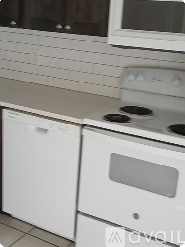A white oven and dishwasher in a kitchen.