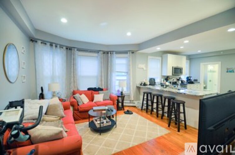 A living room with a red couch and a television.