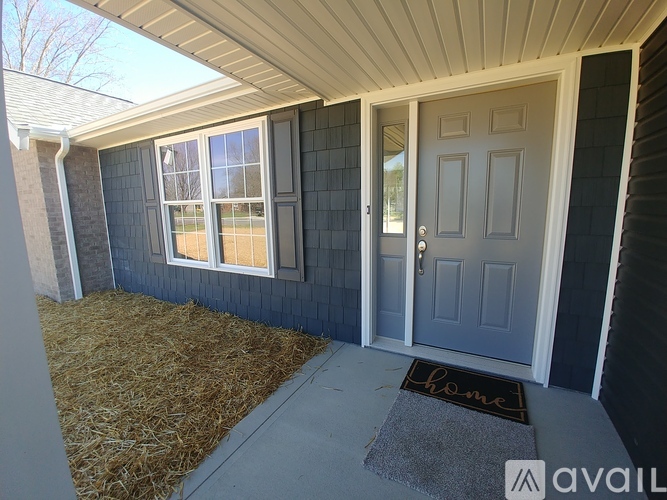A house entrance with a mat that says "home" on it.