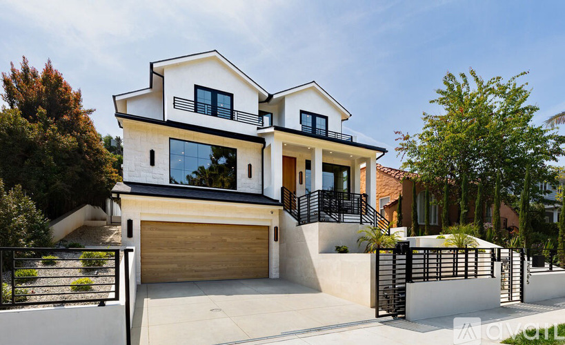 A modern two-story house with a black and white exterior.