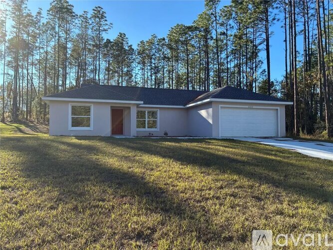 A house with a red door is for sale.