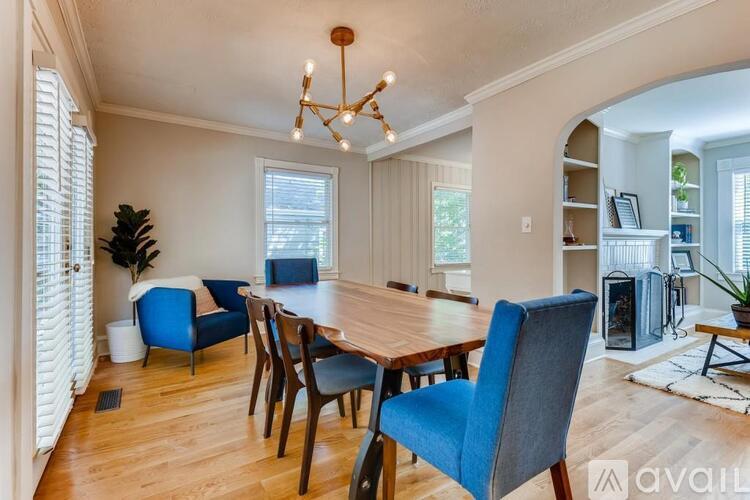 A dining room with a wooden table and blue chairs.