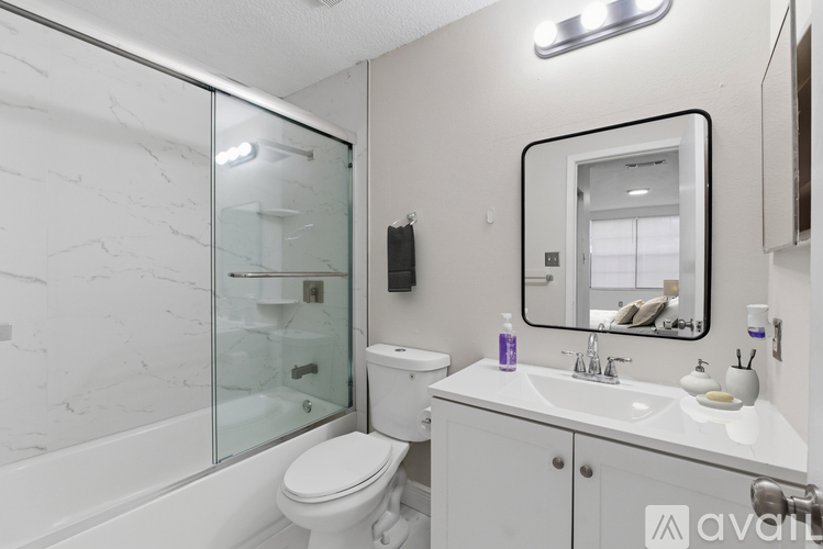 A spacious, empty room with white walls and tile flooring.