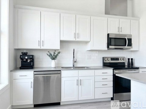 A white kitchen with a microwave above the stove.
