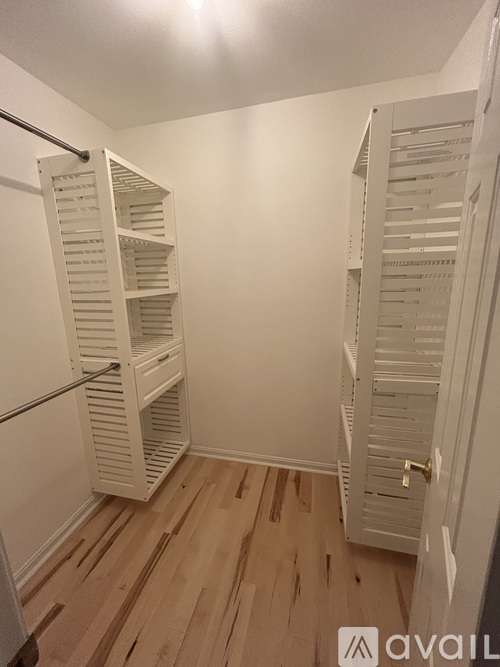 A white closet with a sliding door and shelves.