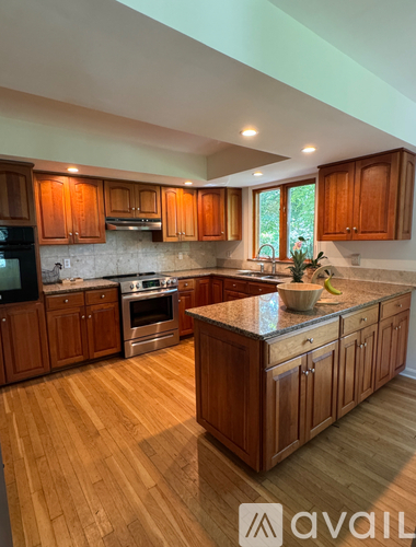 A kitchen with wooden cabinets and a granite countertop.