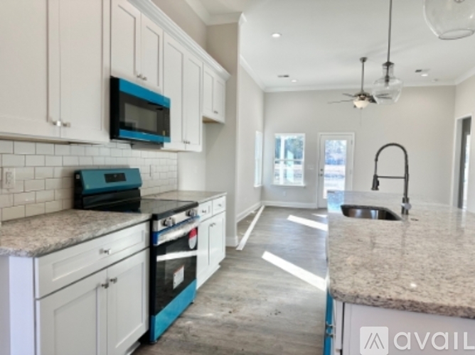A kitchen with a blue oven and microwave.