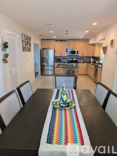 A kitchen with a table set for four.