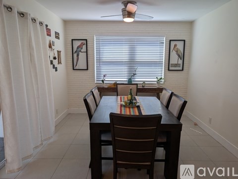 A dining room with a table set for six.