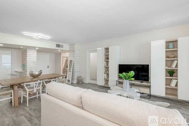 A modern living room with a white couch and a television.