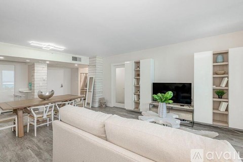 A modern living room with a white couch and a television.