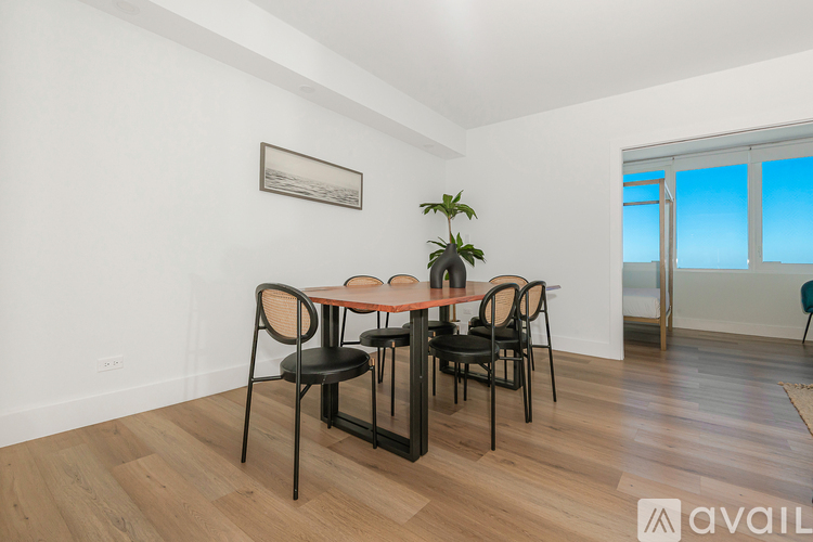 A dining room with a table and chairs.