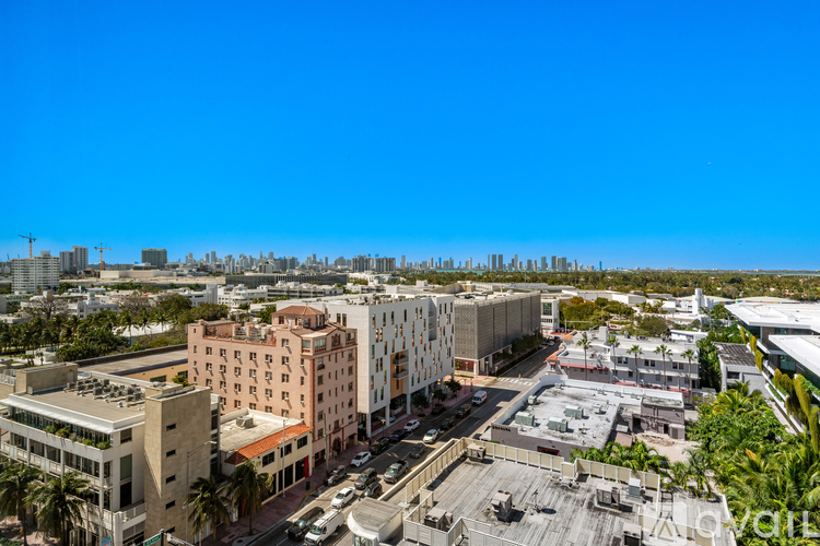 A cityscape with buildings and a clear blue sky.