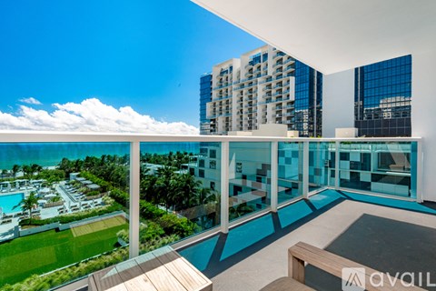 A modern building with a pool and a view of the surrounding area.