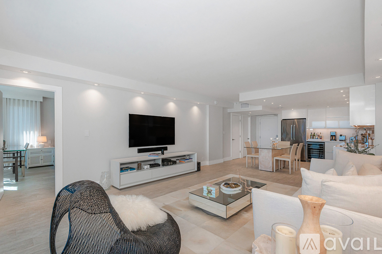 A modern living room with a black chair and a white sofa.