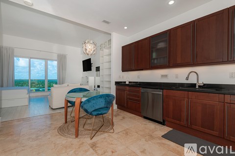 A kitchen with brown cabinets and a blue chair.