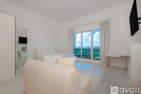 A modern living room with a large window overlooking the city.