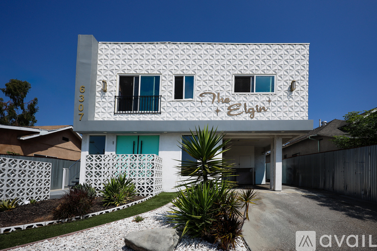 A white building with a sign that says "The Elgin" on it.