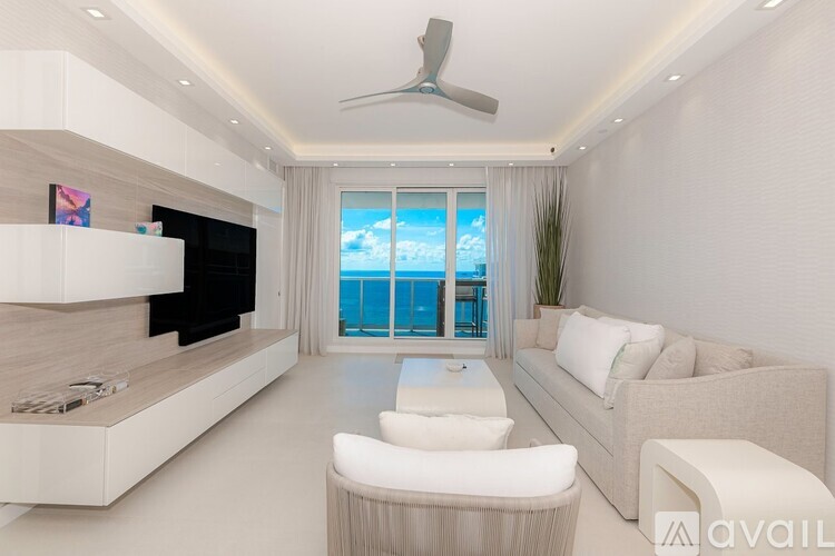 A modern living room with a white sofa and a glass table.