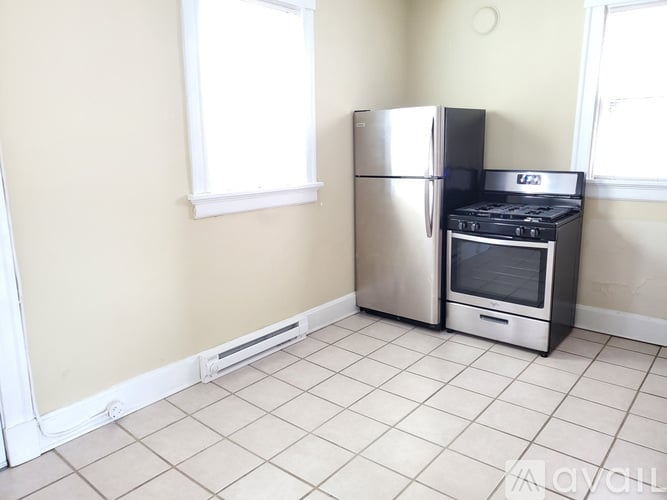 A kitchen with a stainless steel refrigerator and stove.