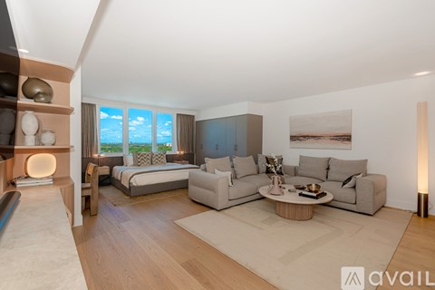 A modern living room with a large window and a view of the sky.