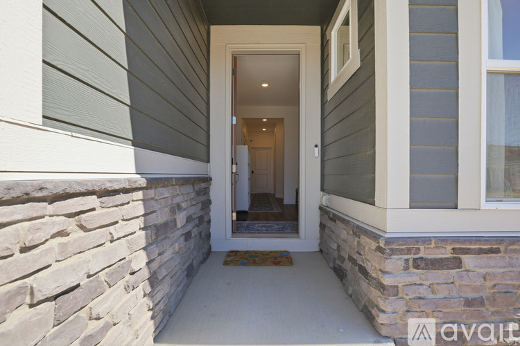 A house entrance with a mat on the floor.