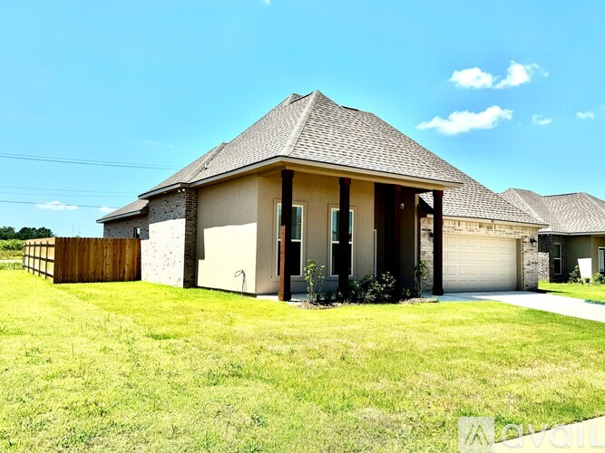 A house with a brown roof and a white garage door.