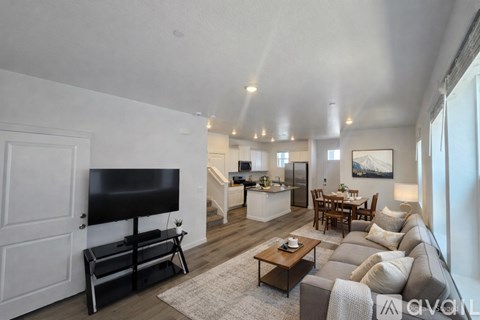 A living room with a grey couch and a black television.