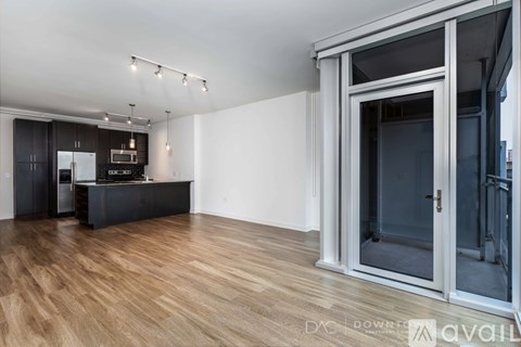 A modern kitchen with wooden floors and a bar area.