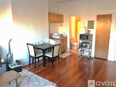 A kitchen area with a dining table and chairs.