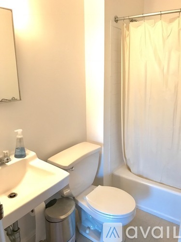 A white toilet sits next to a sink in a bathroom.