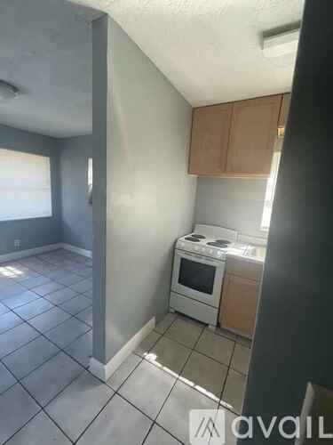 A kitchen with a stove and a window.