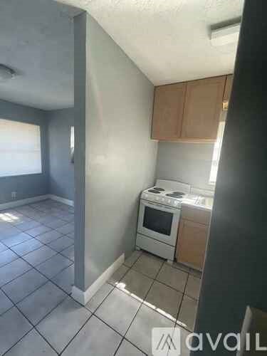A kitchen with a stove and a window.