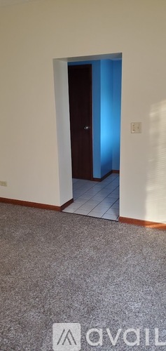 A doorway with a light blue glow coming from the other side.