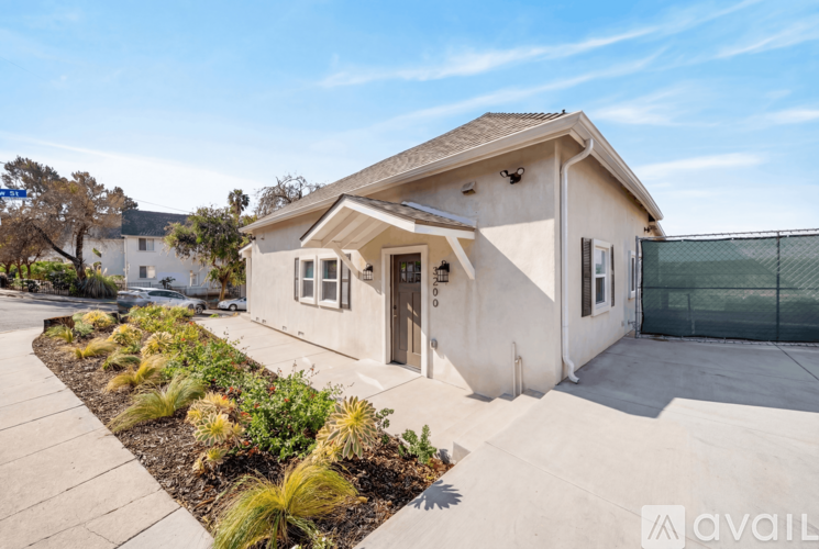 A house with a front yard and a fence.
