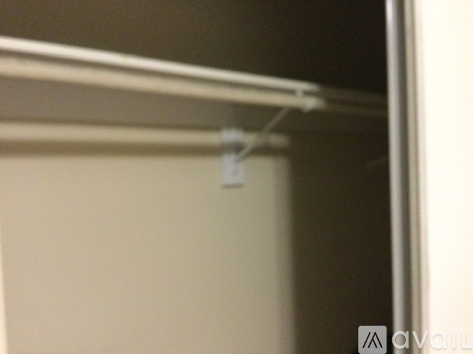 A white shelf is mounted on a wall.