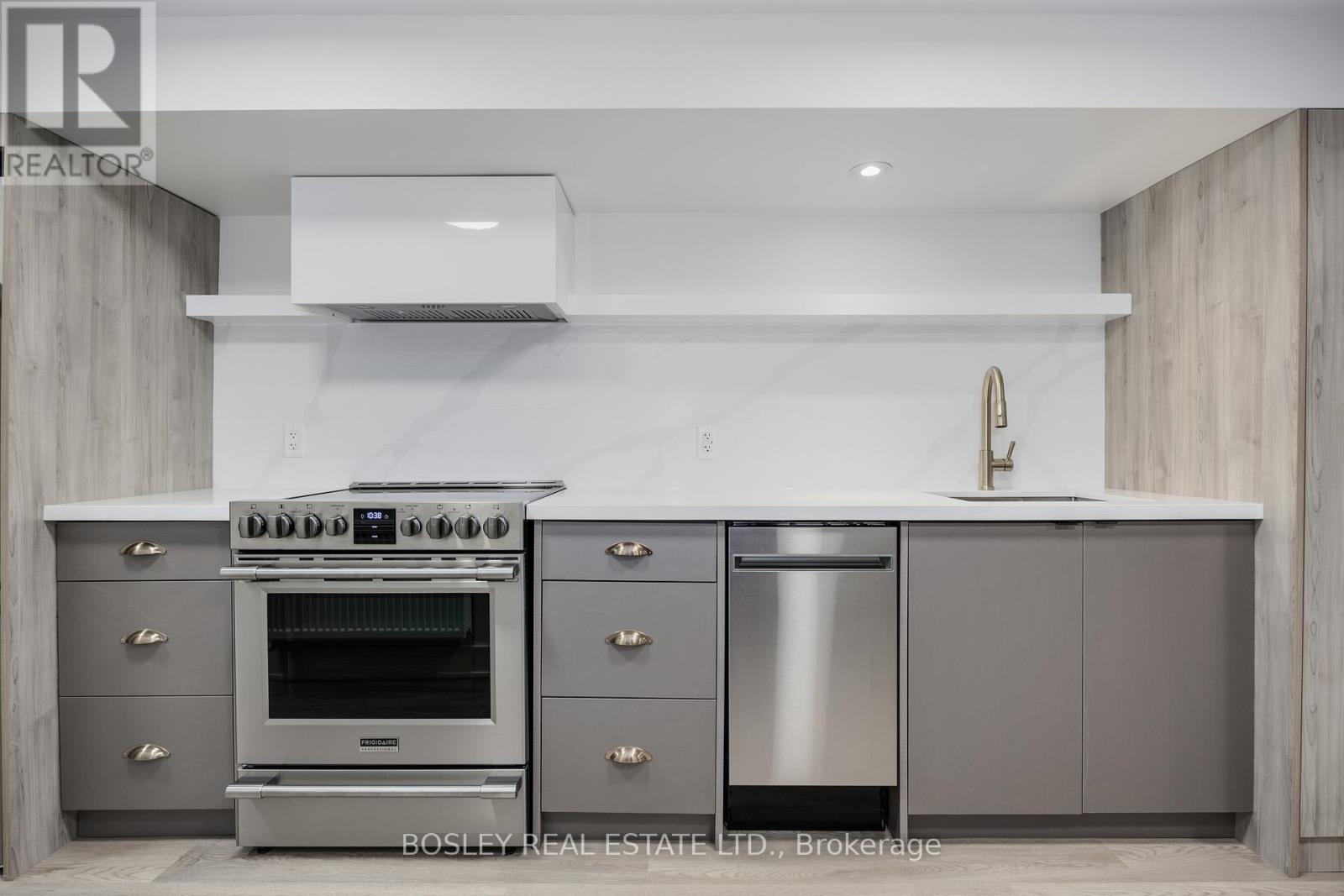 A modern kitchen with a stainless steel oven and dishwasher.
