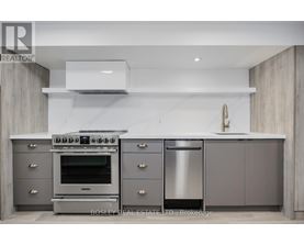 A modern kitchen with a stainless steel oven and dishwasher.
