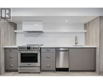 A modern kitchen with a stainless steel oven and dishwasher.
