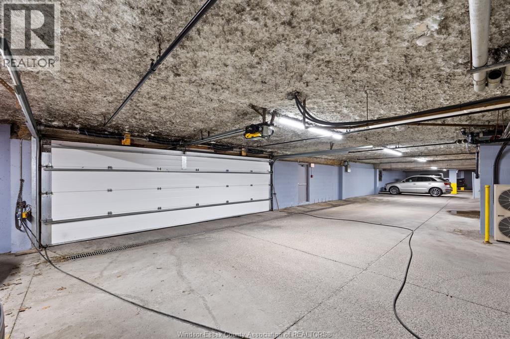 A spacious garage with a car parked inside.