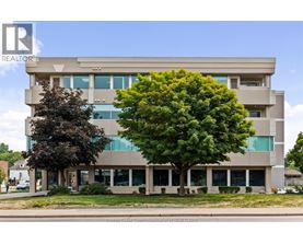A large building with a tree in front of it.