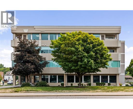 A large building with a tree in front of it.