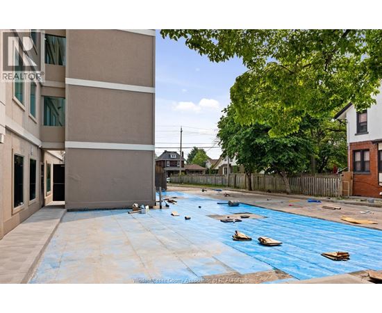 A pool under construction with blue tarp covering the water.