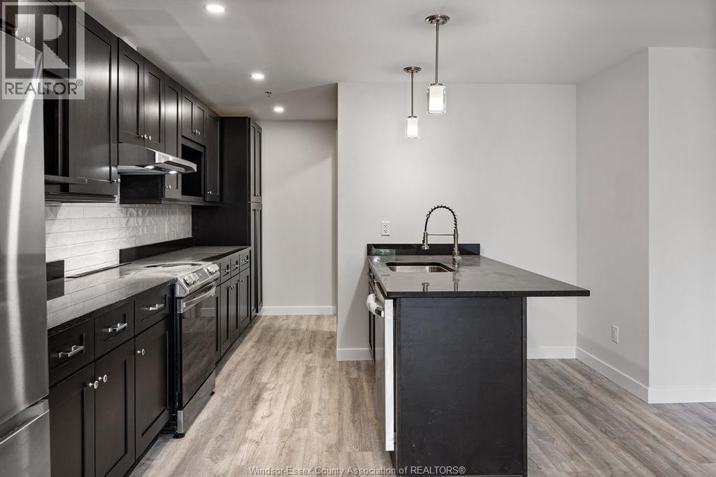 A modern kitchen with dark wood cabinets and a center island.