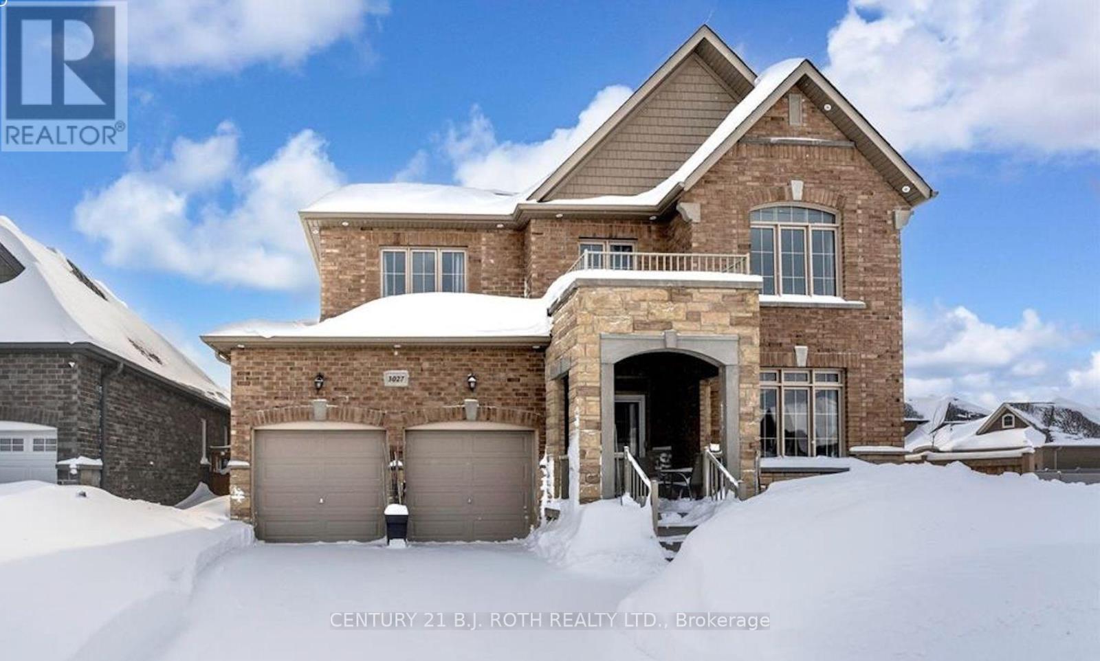 A house with a snow-covered front yard.