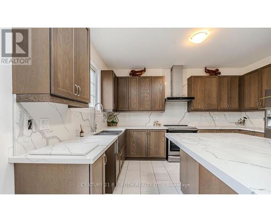 A kitchen with wooden cabinets and marble countertops.